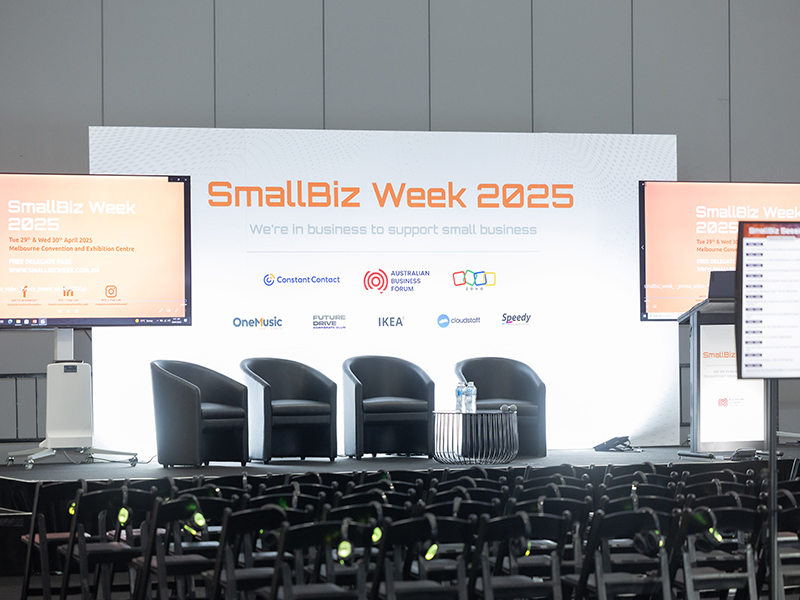 Stage set up with chairs, screens and displays.