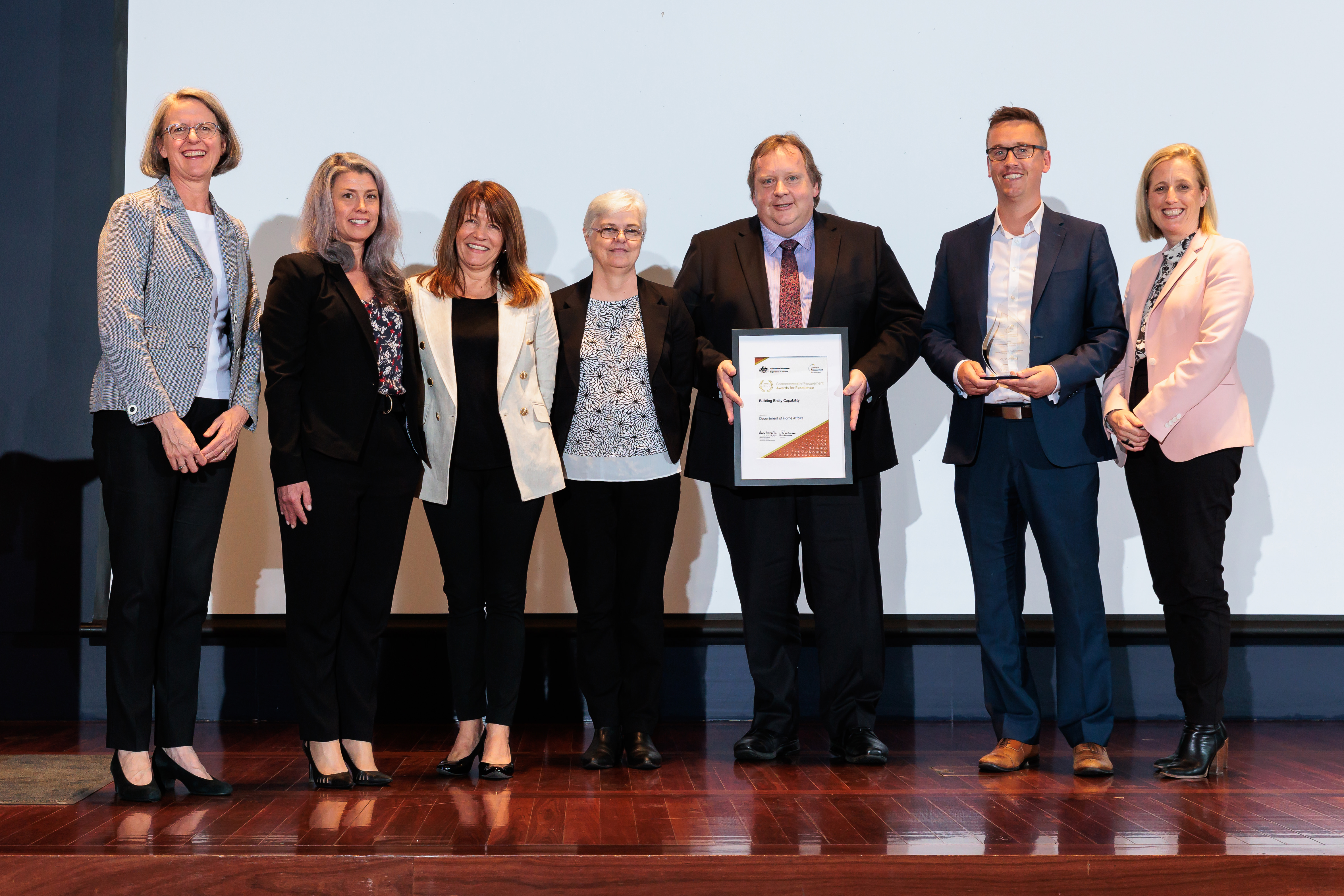 Photograph of Building Entity Capability Gold award recipients - Department of Home Affairs with the Minister for Finance and the Finance Secretary.