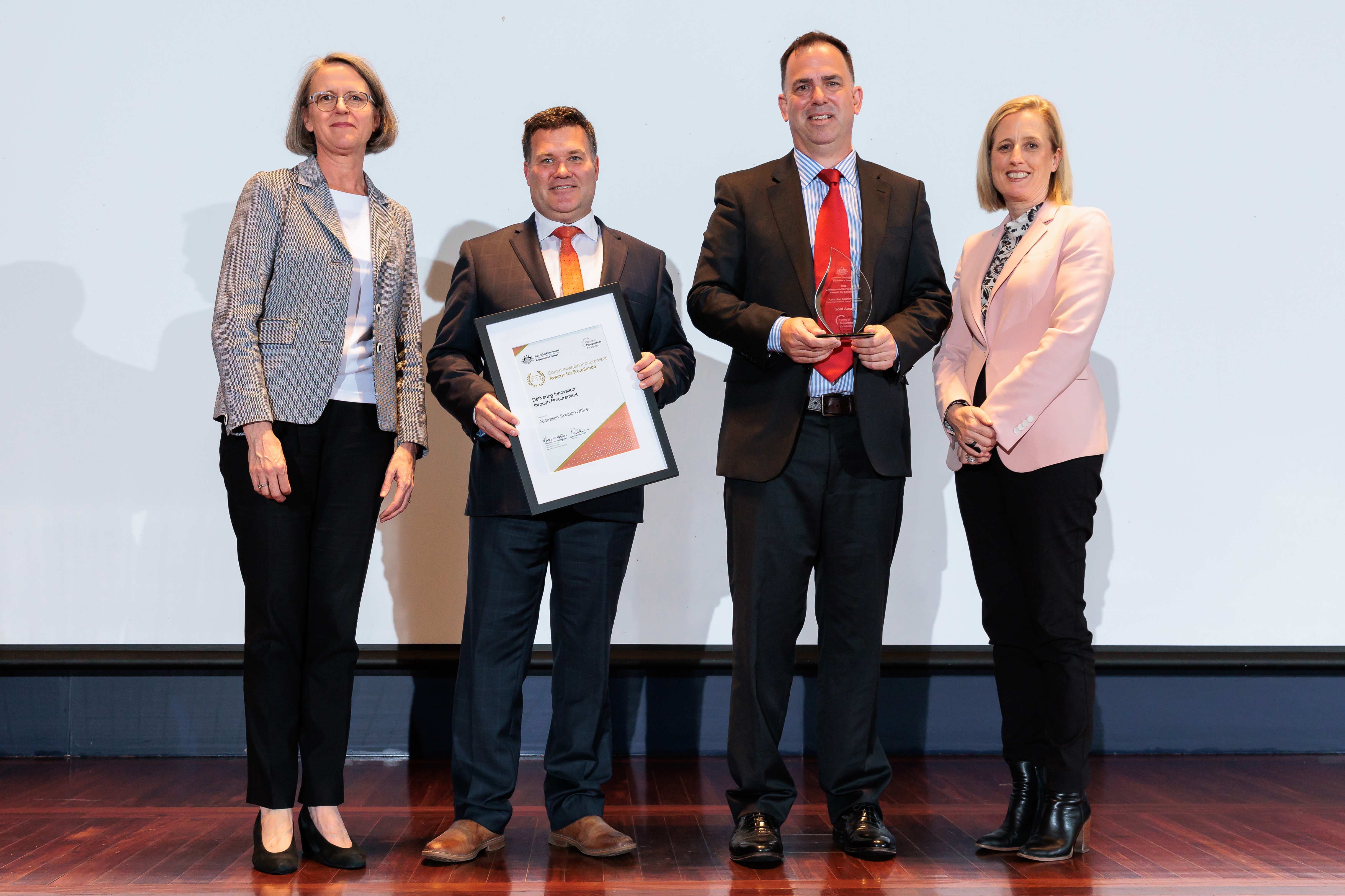 Photograph of Delivering Innovation through Procurement Gold award recipients – Australian Taxation Office with the Minister for Finance and the Finance Secretary