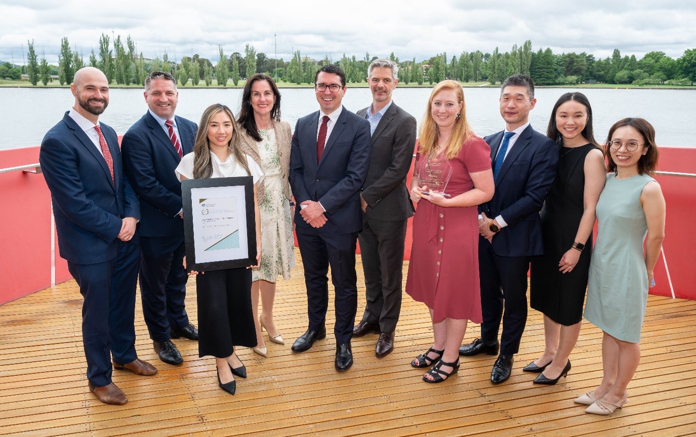 Photograph of the Hon. Patrick Gorman and Deputy Secretary Richard Windeyer with representatives from Australian Prudential Regulation Authority.