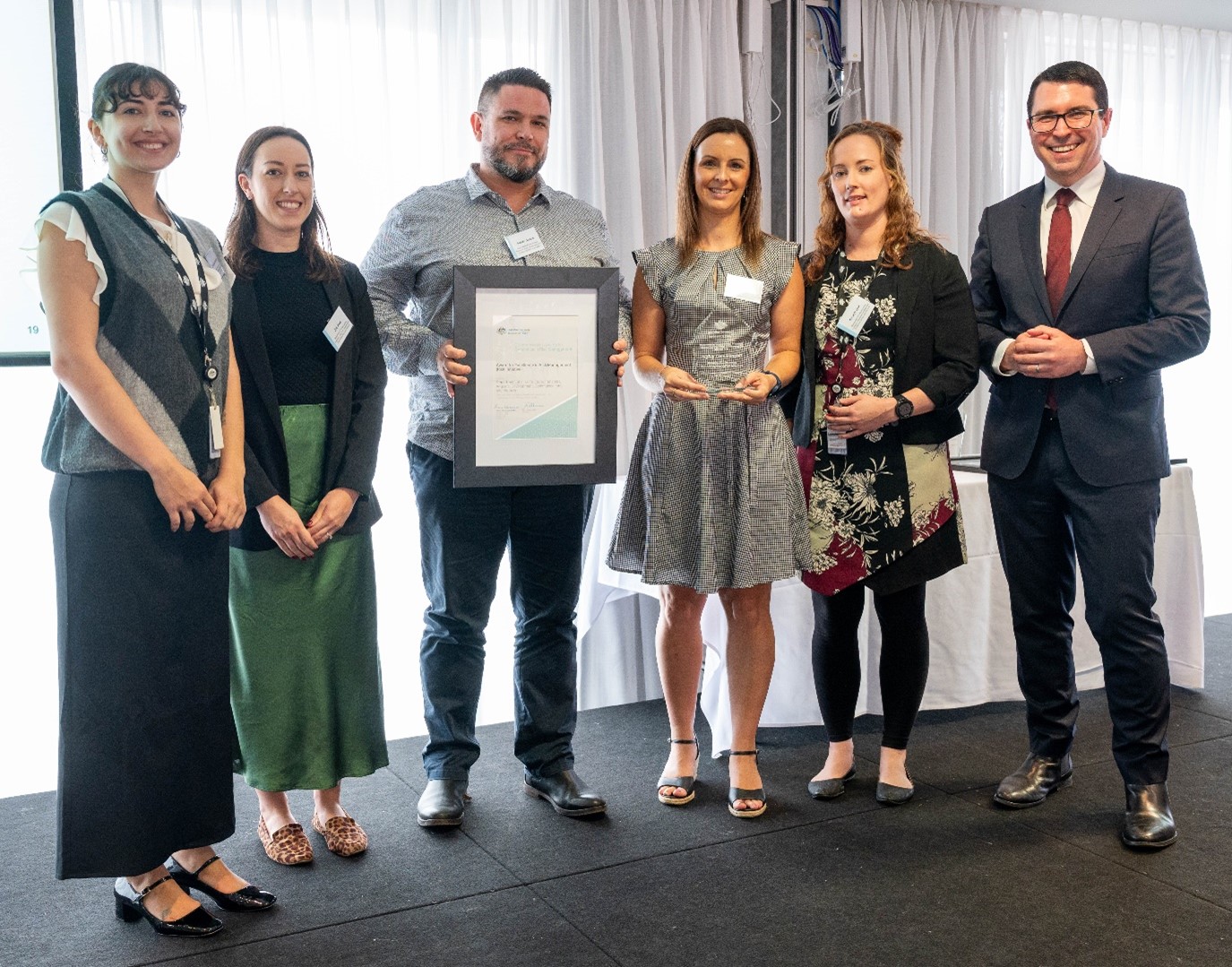 Photograph of the representatives from the Department of Infrastructure, Transport, Regional Development, Communications and the Arts with the Hon. Patrick Gorman. 