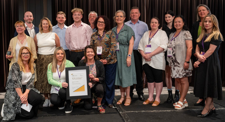 Photograph of the Building Entity Capability Gold award recipients - DCCEEW with the Secretary of the Department of Finance.