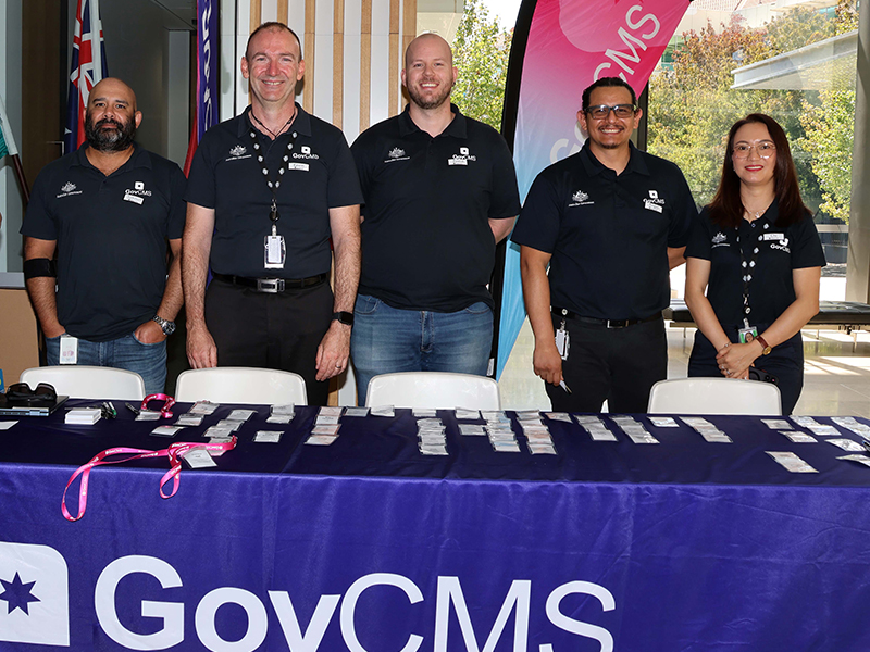 GovCMS team members hand out name tags at the 10th Anniversary Meetup Event