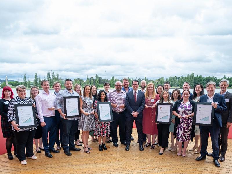 Photograph of the Hon. Patrick Gorman and Deputy Secretary Richard Windeyer with the Award recipients.